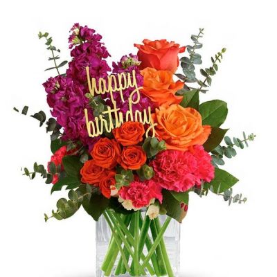 Fill someone's birthday with color! This brightly colored birthday flower bouquet is created with mixed floral stems including orange roses, pink carnations and orange spray roses. All the beautiful flowers are hand arranged by a florist near you in a glass cube vase. Note: Happy Birthday pick may vary depending on local florist's availability.