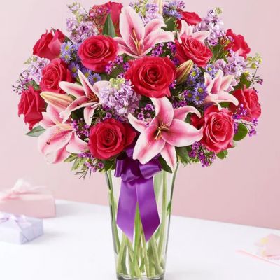 A gift means so much more when it comes from the heart. Our Valentine’s bouquet delivers on that sentiment, with radiant pink and purple blooms arranged in a glass cylinder vase. Finished with a purple satin ribbon, it’s a surprise that speaks volumes about how you feel.