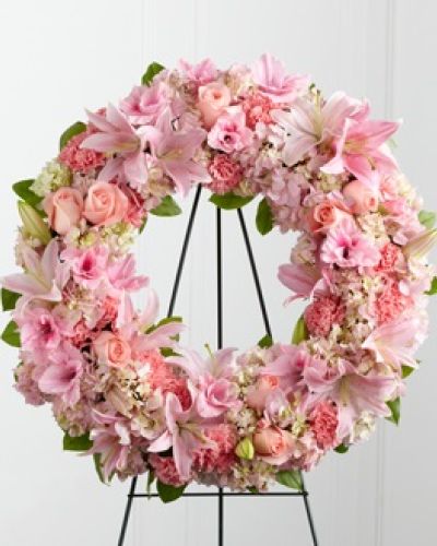 The FTD&reg; Loving Remembrance&trade; Wreath is a blushing display of grace and beauty to honor the life of the deceased at their final tribute. Pink roses, Oriental lilies, gladiolus, hydrangea and carnations are brought together with lush greens to form the shape of a wreath, offering warmth and comfort with its sweetly sophisticated elegance. Displayed on a wire easel.