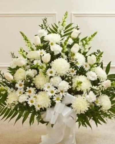 <p>Crafted from striking white blooms, our tasteful floor basket arrangement is a beautiful symbol of your care and concern in this time of sorrow. Hand-gathered with the freshest roses, mums, snapdragons and more, it's a beautiful expression of your sentiments as well as a touching way to remember a loved one who has passed. Appropriate for family, friends or business associates to send directly to the funeral home.</p>