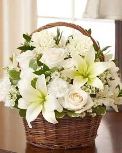 <p>Make a heartfelt gesture of your sympathy with our classic all-white basket arrangement of white roses, lilies, alstroemeria, carnations, mini carnations, and monte casino, accented with variegated pittosporum. Hand-gathered into a lovely willow handled basket, it's a simple yet touching way to offer peace and comfort during this time of sorrow. Appropriate to send to the home of friends and family members or to the memorial service.</p>