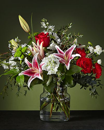 Inspired by the crisp colors of a candy cane, our Peppermint Swirl Bouquet is a fun and festive holiday delight. The starfighter lily's white exterior will bloom with bright color on the inside, complementing the classic ruby carnations.