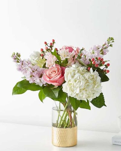 Tickle them pink with this elegant arrangement of roses, alstroemeria, hypericum berries, and carnations set in a gold&ndash;dipped vase. As elegant as a string of pearls, add a touch of class to any room with roses and gerbera daisies.