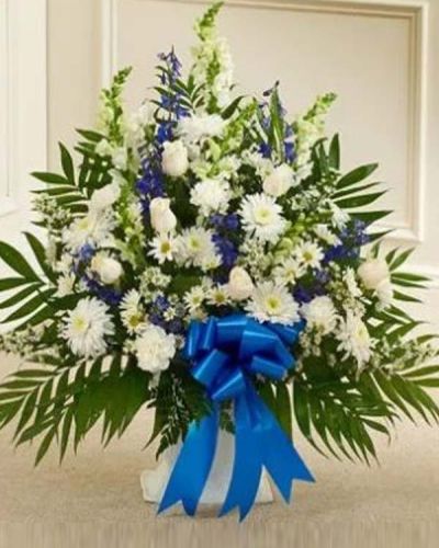Our elegant floor basket arrangement is a heartfelt way to express your deepest sympathies. With blue flowers to symbolize tranquility and white flowers to symbolize peace, this beautiful gathering of fresh roses, snapdragons carnations, blue delphinium and more conveys care and concern during this difficult time. Appropriate for family, friends or business associates to send directly to the funeral home.