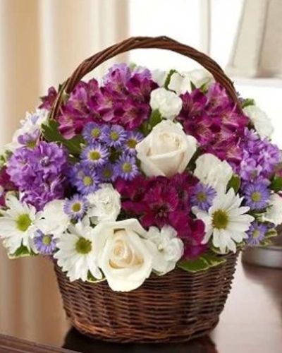 <p>Express your heartfelt sympathy with a graceful arrangement of peaceful lavender and white blooms such as roses, stock, alstroemeria, daisy poms, mini carnations and monte casino accented with variegated pittosporum and myrtle. Designed by hand in a lovely basket, it's a beautiful tribute to a life well lived. Appropriate to send to the home of friends and family members or to the memorial service.</p>