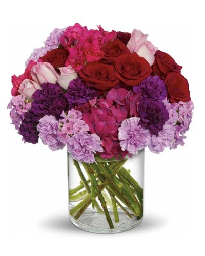 <p>What does a grand and Sweeping Romance look like? It's full of the blooms of true love. Beautiful dark pink hydrangea, red and lavender roses, carnations in dark purple and lavender, hot pink freesia and lavender phlox are perfectly arranged in a lovely cylinder vase. Get swept away with this Love-ly bouquet.</p>