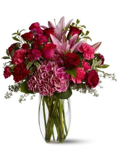 Make a lovely lady blush with a generous mix of wine-hued blossoms such as roses, hydrangea, Asiatic lilies and more - in rich shades of burgundy, red and pink - delivered in a simple glass vase. With over half a dozen different varieties of flowers, it's a colorful and rare gift for any occasion. A mix of red, pink and burgundy flowers such as roses, Asiatic lilies, hydrangea, carnations and Sweet William &ndash; accented with greenery &ndash; is arranged in a clear glass vase.