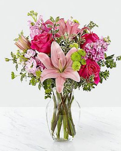 The Pink Posh Bouquet is chic and pink to help you celebrate life's most treasured moments in style! Hot pink roses are bright and beautiful arranged amongst pink Asiatic Lilies, pink gilly flower, green button poms, bupleurum and lush greens to create that perfect gift of flowers. Presented in a clear glass vase, this blushing fresh flower arrangement is ready to send your sweetest wishes in honor of a birthday, an anniversary, or as a way to express your thanks and gratitude.
STANDARD bouquet is approx. 16H x 13W.
DELUXE bouquet is approx. 17H x 14W.
PREMIUM bouquet is approx. 18H x 15W.