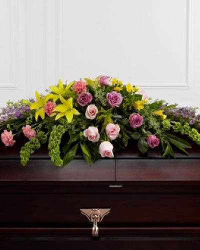 <p>The FTD® Forever Beloved™ Casket Spray beautifully illuminates the atmosphere of their final farewell service. Lavender roses, pink roses, lavender larkspur, pink carnations, Bells of Ireland, yellow Asiatic lilies, yellow freesia, solidago and lush greens are arranged to create an extravagant display of floral beauty that offers comfort and peace to the friends and family of the deceased.</p>