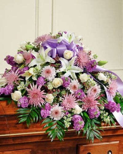<p>Celebrate a beautiful life with this heartfelt expression of your love, sympathy and devotion to a departed family member or loved one. Our expert florists craft the freshest blooms of long-stem white roses and oriental lilies, lavender cremones, stock and more into this half casket cover for an unforgettable final tribute. Traditionally sent by the immediate family to the funeral home.</p>