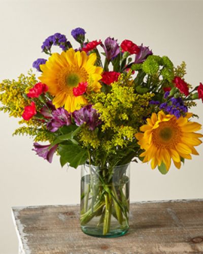 Summer in the Cape has all the seasons&rsquo; favorites like sunflowers, alstromerias, button pompoms and more. Crafted by an expert florist, this arrangement has bold and beautiful colors that remind you of warm days and spending time with the ones you love.