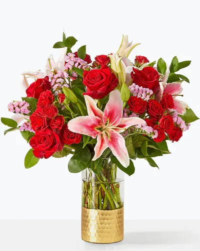 <p>A swoon-worthy bouquet that speaks the language of love, artfully arranged by a local florist with red roses, lilies, and statice.</p>
