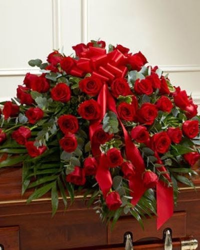 <p>Red roses are a powerful symbol of undying love. This half casket cover, crafted with exquisite care by our expert florists, features long stem red roses and vibrant greenery for a beautiful and fitting final tribute. Traditionally sent by the immediate family to the funeral home.</p>