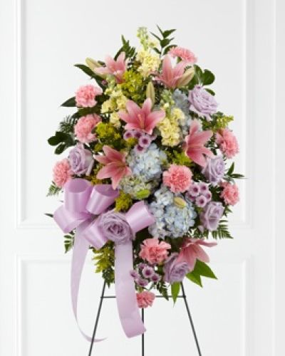 <p>The FTD® Blessings of the Earth™ Easel is a soft and serene arrangement that elegantly honors the life of the deceased. Lavender roses, pink carnations, pink Asiatic lilies, blue hydrangea, yellow stock, lavender button poms, solidago and lush greens are beautifully accented with a lavender satin ribbon and displayed on a wire easel to create a gorgeous display for their memorial service.</p>
