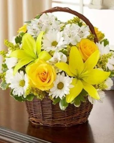 <p>Send a touching gesture of peace and comfort to the home or service with our graceful yellow and white arrangement of roses, lilies, alstroemeria, daisy poms, mini carnations and solidago, accented with variegated pittosporum and myrtle. Elegantly arranged in a handled willow basket, it's a lovely tribute to a loved one who has passed away. Appropriate to send to the home of friends and family members or to the memorial service.</p>
