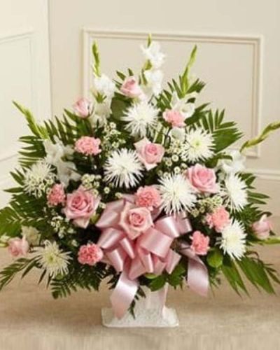 <p>The Touching Tribute Floor Basket is a meaningful way to express your care and concern. With pink flowers to symbolize admiration and appreciation for a life well lived and white flowers to symbolize peace and respect, this gathering of fresh pink roses, white spider mums, white snapdragons, pink carnations and more delivers beauty and hope to a difficult time. Appropriate for family, friends or business associates to send directly to the funeral home.</p>