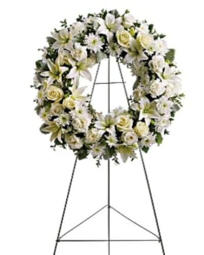 <div id="mark-1" class="m-pdp-tabs-marketing-description">Fragrant and ethereal white blossoms set among a ring of soothing greens form a classic wreath certain to evoke the pure heart and gentle spirit of a loved one &ndash; and offer consolation during a funeral or wake.</div>
<div id="desc-1">
<ul>
 	<li>Delivered on an easel, a standing wreath comprising fresh flowers such as white roses, asiatic lilies, carnations and chrysanthemums, as well as greens including salal, oregonia and dusty miller.</li>
</ul>
</div>