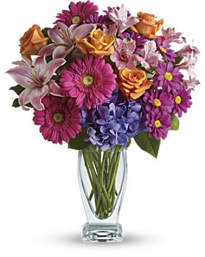 Featuring a wide, wondrous assortment of blooms in one bouquet, this colorful arrangement is always a favorite! Hydrangea, roses, lilies, alstroemeria, gerberas, daisies - they're all here in stunning variety.
This versatile mix includes blue hydrangea, orange roses, light pink asiatic lilies, pink alstroemeria, hot pink gerberas and purple daisies with a bit of rich green salal.