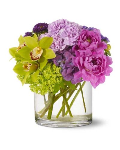 This Ethereal Beauty Bouquet captures all the delicate tones of a watercolor painting. Green orchids and purple dahlias mingle with lavender and chartreuse blooms to create a vision of pure beauty arranged in a cylindrical clear glass vase.