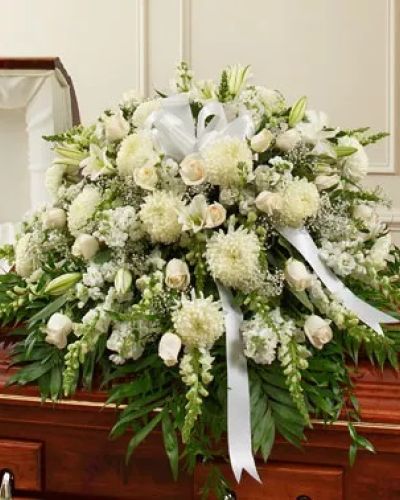 Reverence. Honor. Remembrance. Peace. All of these thoughts are expressed beautifully with this elegant tribute. Crafted by our expert florists from pure white blooms such as fresh white roses, lilies, mums, snapdragons and more, it makes a beautiful final tribute. Traditionally sent by the immediate family directly to the funeral home.