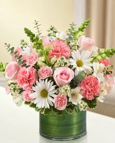 <p>Make an elegant gesture of condolence with a beautiful arrangement of pink roses and carnations, gathered with white snapdragons, alstroemeria and daisy poms. This graceful arrangement is hand-designed by our expert florists in a stylish clear glass cylinder vase wrapped with a Ti leaf ribbon.</p>
