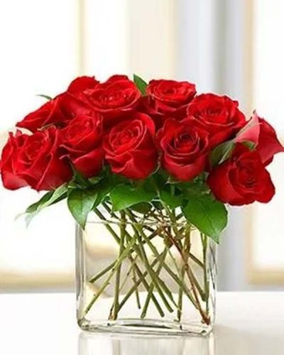 <p>Surprise her with this modern spin on the traditional dozen roses. Stunning red roses are gathered in a chic rectangular glass vase and accented with a fashionable butterfly pick. Also available in pink, yellow and assorted.</p>