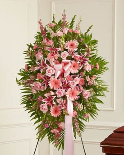 This Profound Sympathies Standing Spray in shades of pink is a beautiful symbol of your sympathy and support. It is expertly crafted with roses, stargazer lilies, larkspur, snapdragons and more. An appropriate gift for family, friends and business associates to send directly to the funeral home.